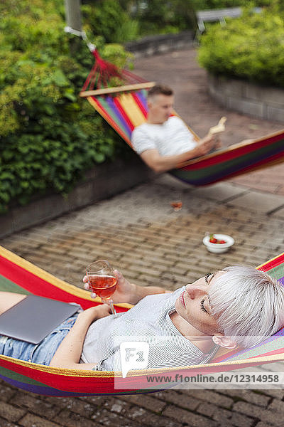Couple relaxing on hammocks