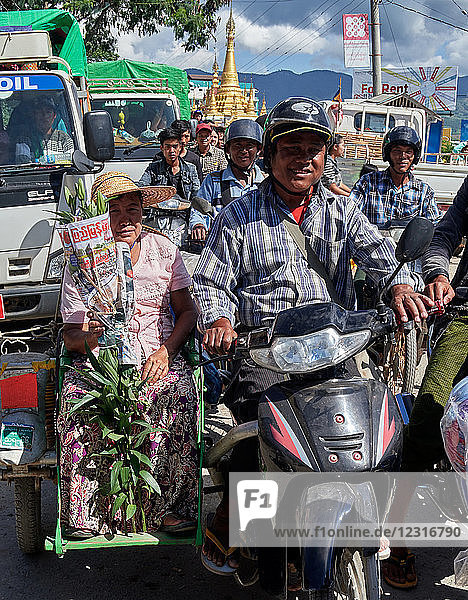 Nyaungshwe ( YAUNGHWE) city; Inle lake Shan state  Myanmar (Burma)  Asia ; A laden motorcycle   taxi; A busy street scene