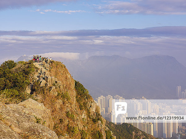 Hikers at the Lion Rock mountain peak  viewing the city of Hong Kong from a high point  Hong Kong  China  Asia
