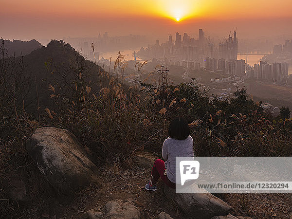 Tourist enjoys watching sunset of Chongqing skyline from the Nanshan mountain  Chongqing  China  Asia