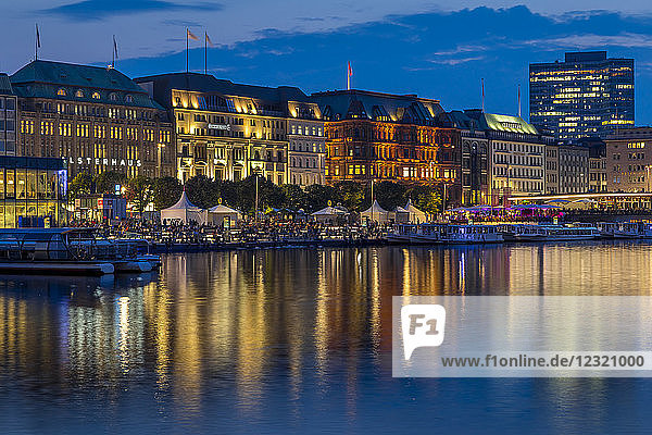 Illuminated buildings at Jungfernstieg and the Inner Alster at dusk  Hamburg  Germany  Europe