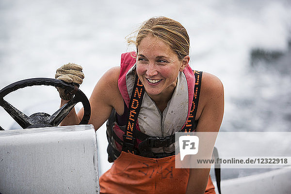 Woman set-netter drives a set-net skiff in Seldovia Bay South-central Alaska; Alaska United States of America