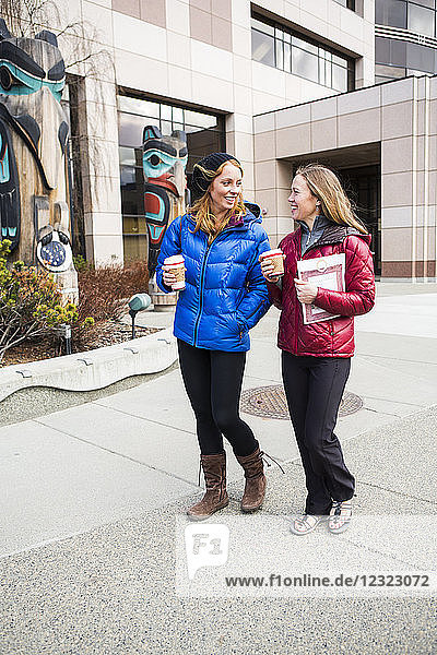Two young women hanging out in downtown Anchorage  South-central Alaska; Anchorage  Alaska  United States of America