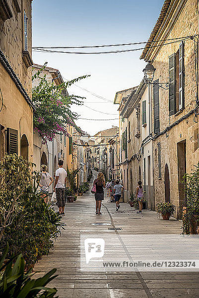 Tourists in one of Alcudia's narrow streets; Alcudia  Mallorca  Balearic Islands  Spain