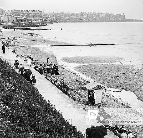 Magic lantern slide circa 1900.Victorian/Edwardian.Social History. Bridlington Bay  Prince’s Parade. A view of the beach houses and quay with people enjoying a day out