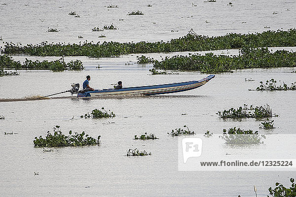 Ein junger Mann in einem Motorboot auf dem Tonle Sap; Siem Reap  Kambodscha
