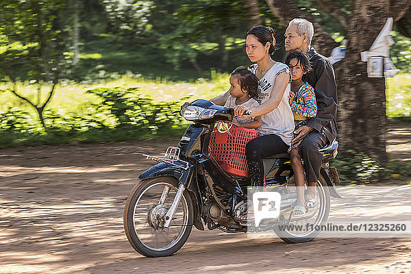Cambodian family riding a motorcycle  Beng Meala; Siem Reap  Cambodia