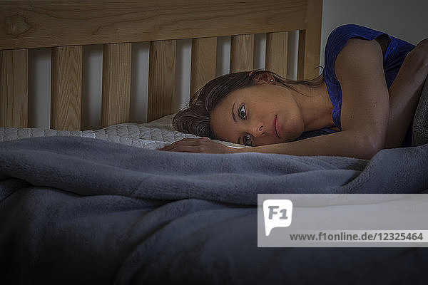Eine Frau liegt mit offenen Augen auf ihrem Bett; Connecticut  Vereinigte Staaten von Amerika