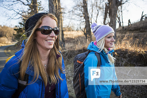 Two young women on a hike on a trail; Anchorage  Alaska  United States of America