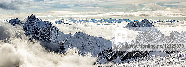 Panorama von schneebedeckten Berggipfeln mit wolkenverhangenen Gipfeln; Grainau  Bayern  Deutschland