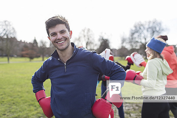 Portrait smiling  confident man boxing in park