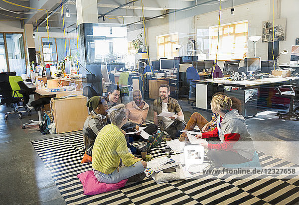 Creative business team meeting  brainstorming in circle on floor