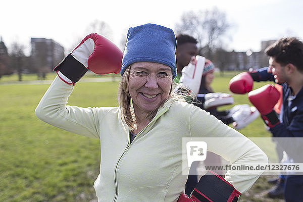Portrait smiling  confident senior woman boxing in park