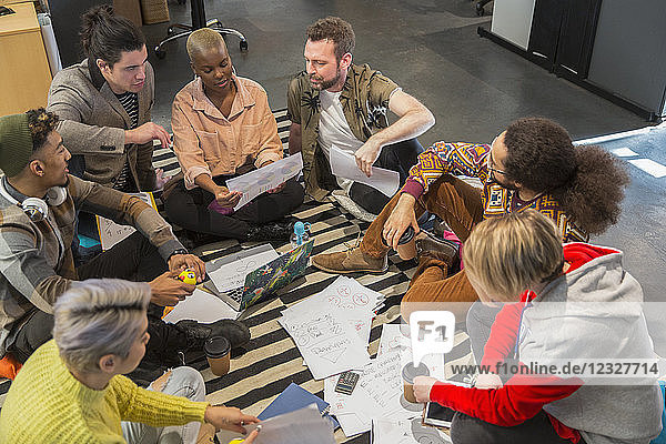 Creative business people meeting  brainstorming in circle on floor
