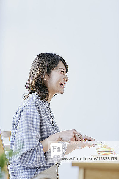 Young Japanese woman eating pancakes