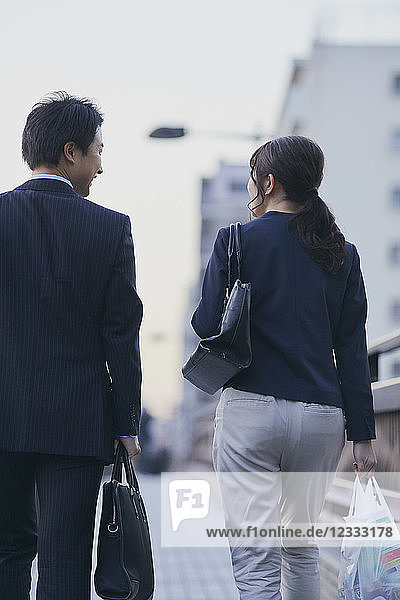 Japanese couple walking home from work