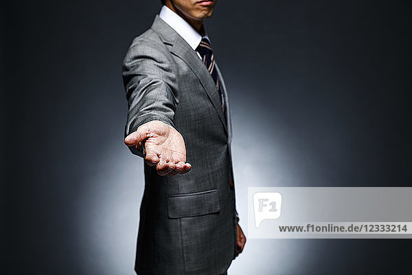 Japanese businessman against grey background