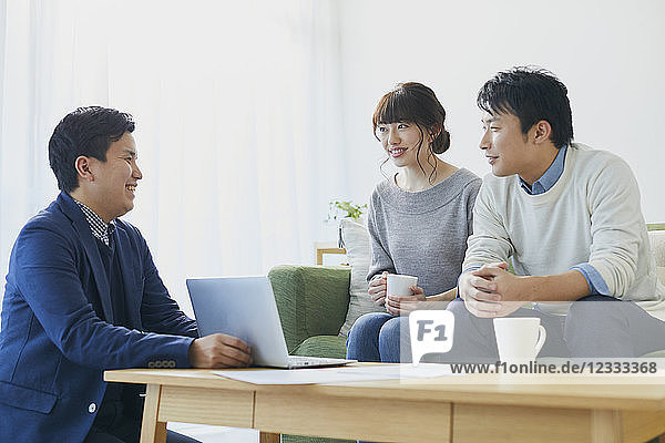 Japanese couple talking with salesman
