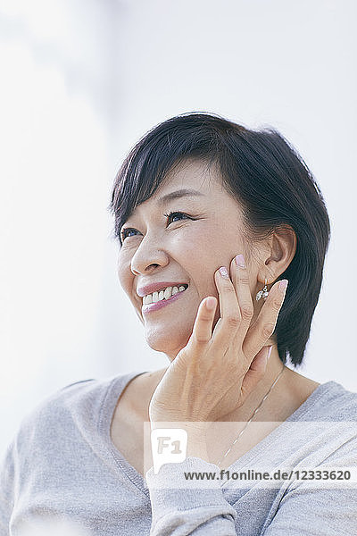 Japanese senior woman doing skin care