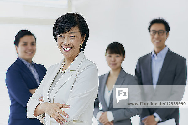 Japanese senior businesswoman with her team