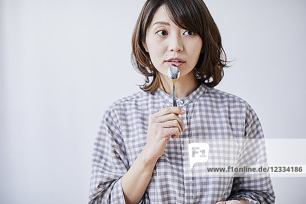 Young Japanese woman eating cake