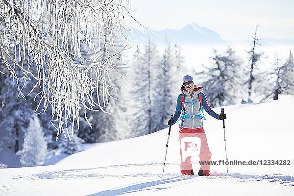 Austria  Tyrol  smiling snowshoe hiker standing in snow