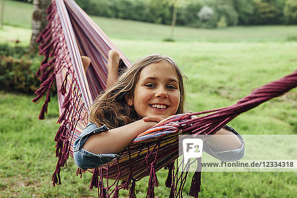 Portrait of happy girl lying in hammock
