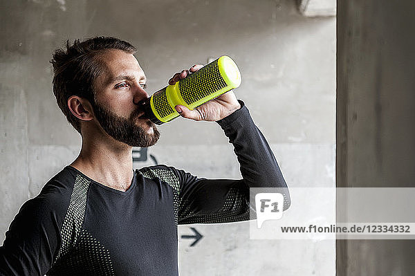 Portrait of athlete drinking from bottle