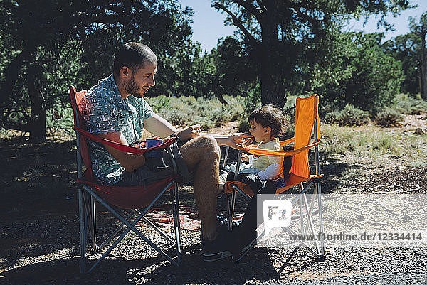 USA  Arizona  Grand Canyon National Park  father and daughter eating outdoors