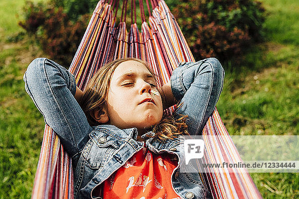 Portrait of little girl relaxing in hammock