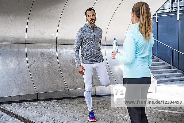 Active couple with water bottle in the city