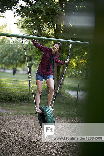 Young woman having fun on a swing