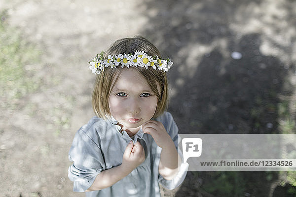 Portrait of blond little girl wearing flowers
