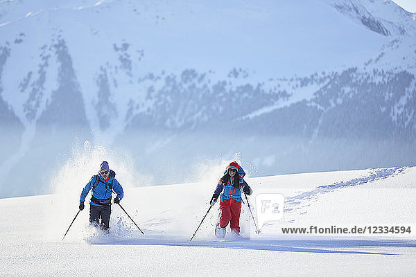 Austria,  Tyrol,  snowshoe hikers running through snow