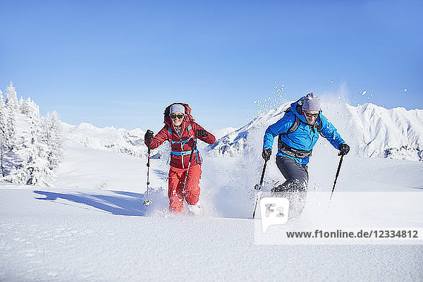 Austria  Tyrol  snowshoe hikers running through snow