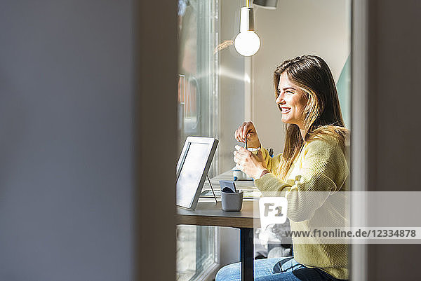 Smiling young woman in a cafe