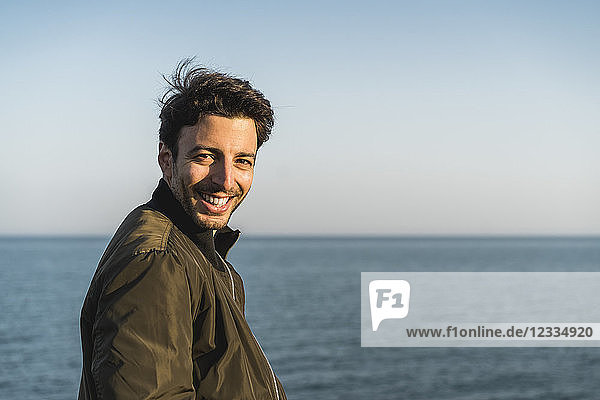 Portrait of smiling young man at the beach