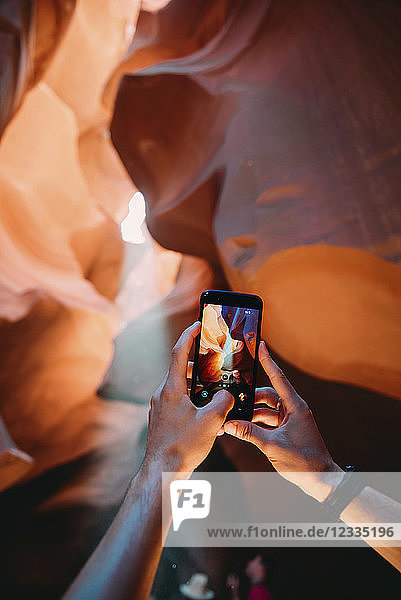 USA  Arizona  Man taking photo with mobile in Antelope Canyon