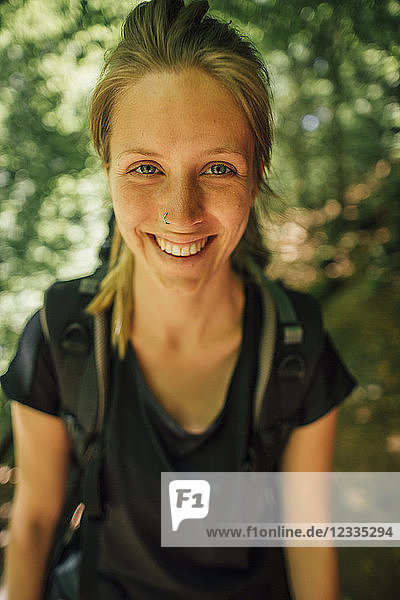 Portrait of smiling young woman on a hiking trip