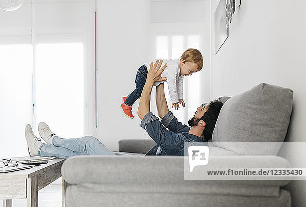 Father playing with his daughter at home