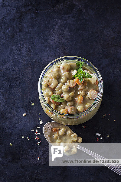 Glass of pea stew with sausage