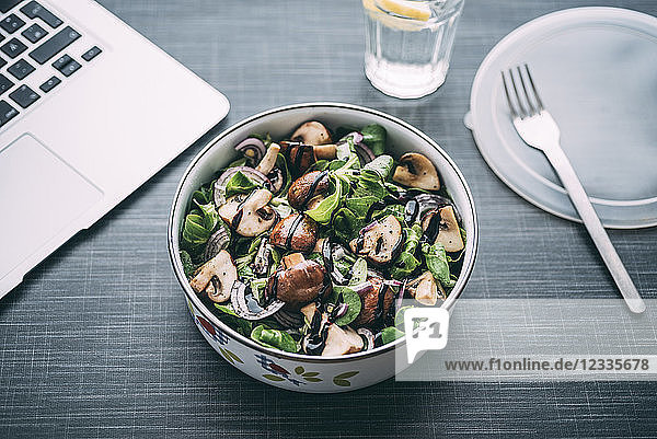 Lunch box with field salad  onions  roasted mushrooms  onions and balsamico