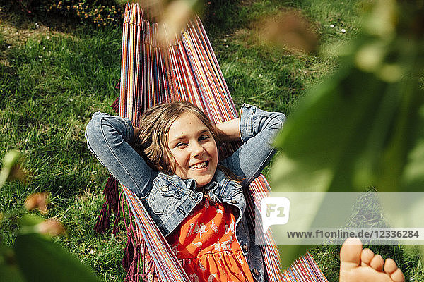 Portrait of smiling girl relaxing in hammock