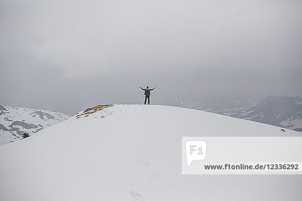 Austria  Kitzbuehel  back view of happy man enjoying snow-covered landscape