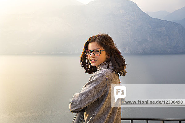 Italy  Brenzone  portait of smiling girl on balcony