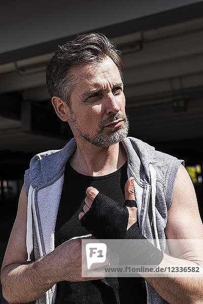 Man bandaging hands for boxing training