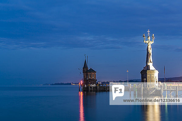 Germany  Constance  view to port entrance with lighthouse and Imperia at twilight
