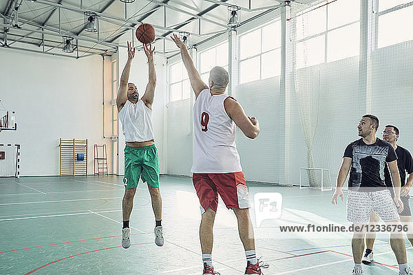 Men playing basketball  indoor