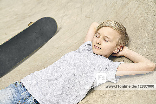 Boy relaxing in skatepark