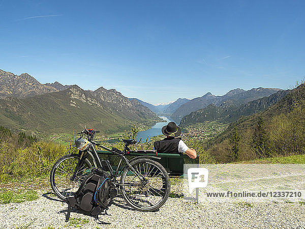 Italy  Lombardy  Senior hiker looking over Idro lake  Adamello Alps  Parco Naturale Adamello Brenta